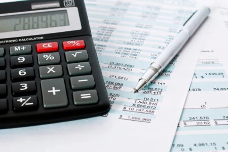 small business bookkeeping tips with a calculator and financial documents